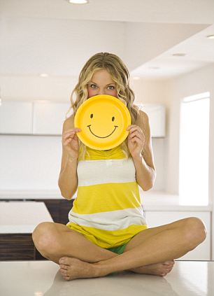 Young Woman Holding Smiley Face